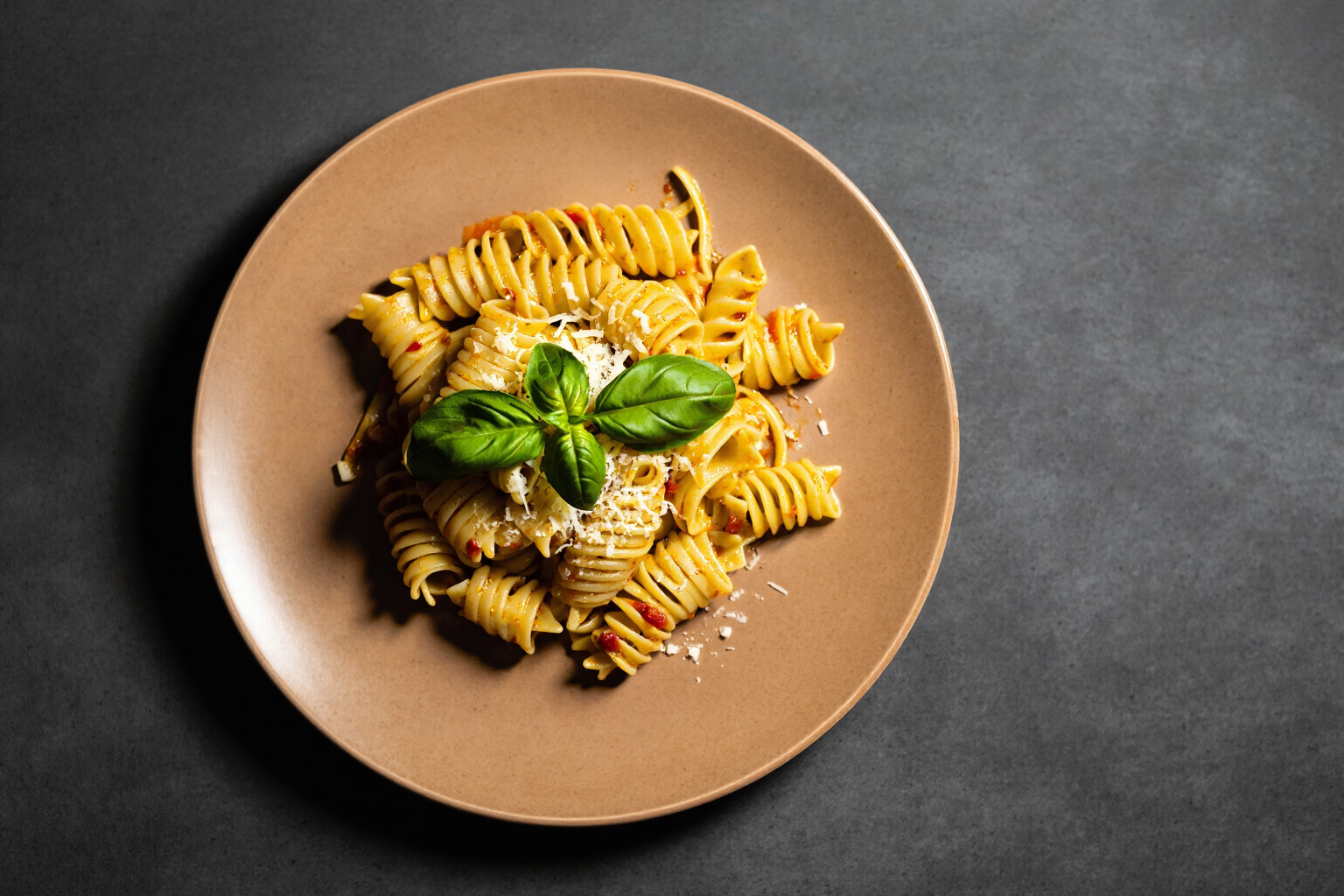 Food and beverage example prompt result showing a plated pasta dish photographed overhead on a dark tabletop