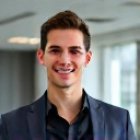 portrait of a young entrepreneur in his late 20s wearing casual business clothes, smiling while looking at camera against a co-working space background